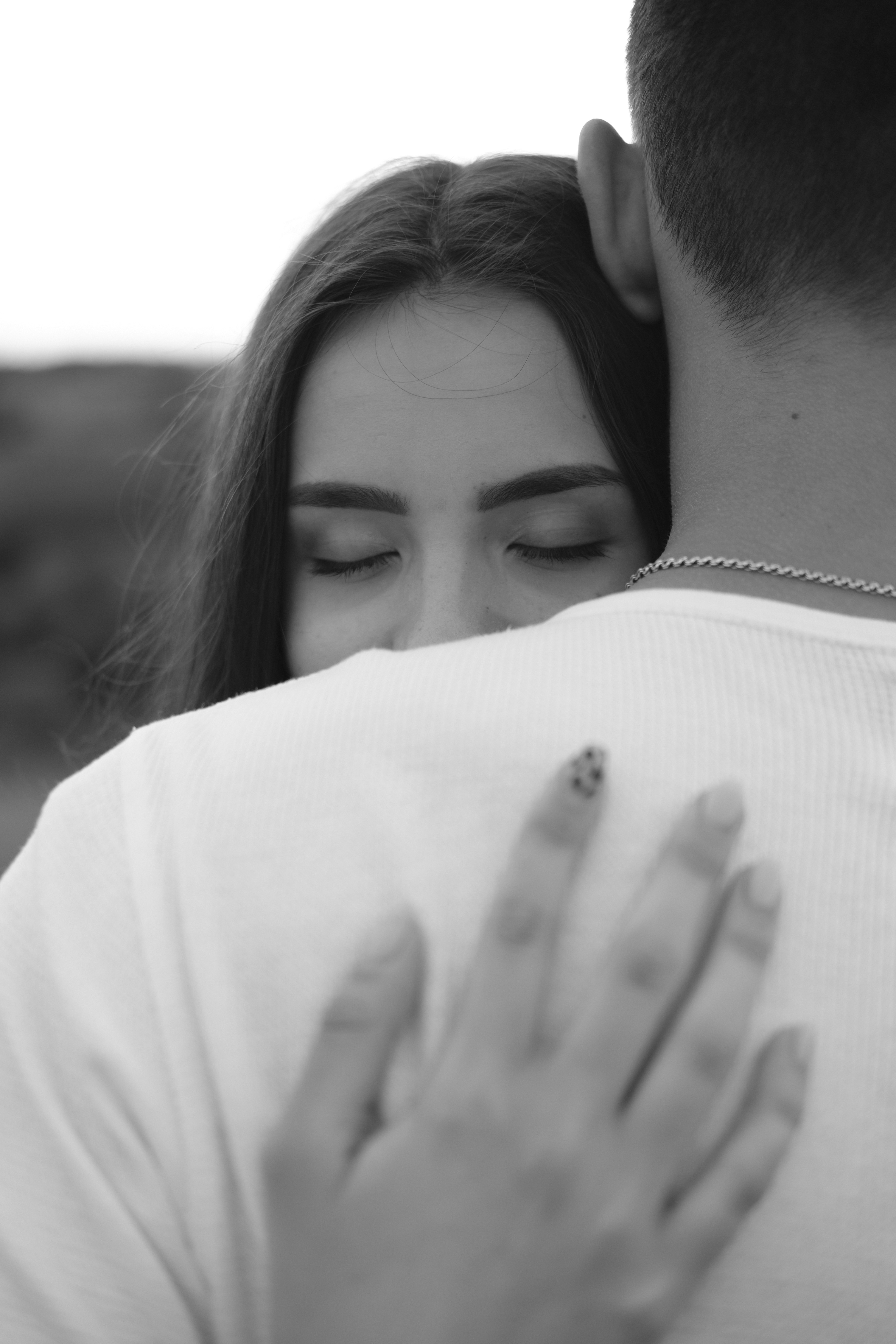 woman in white shirt covering her face with white textile